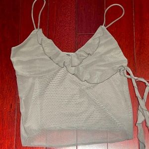 grey mesh tank top. breast area is covered but torso is see-through.